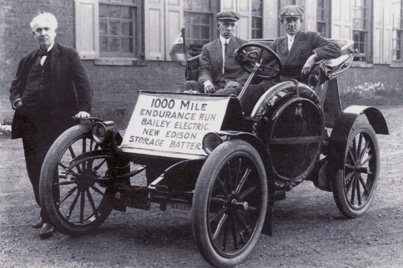 Edison in front of one of his electric vehicle prototypes